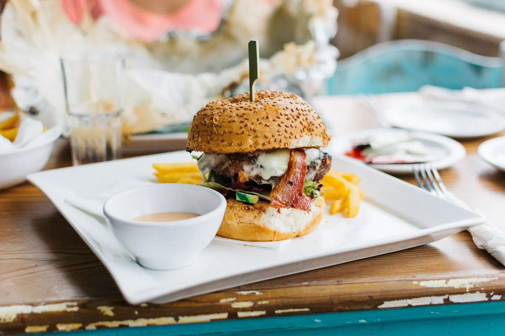 A hamburger sitting on top of a white plate.