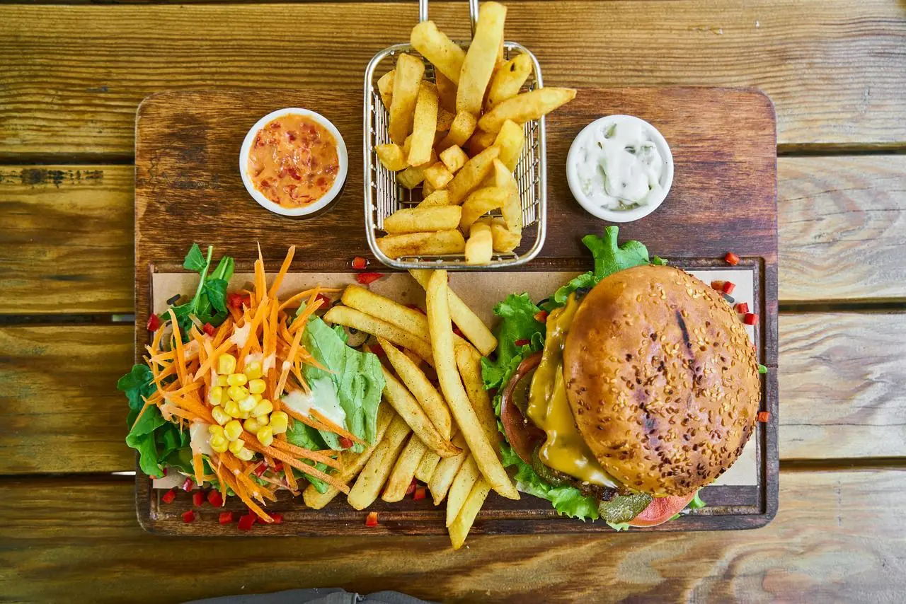 A wooden table topped with lots of food.