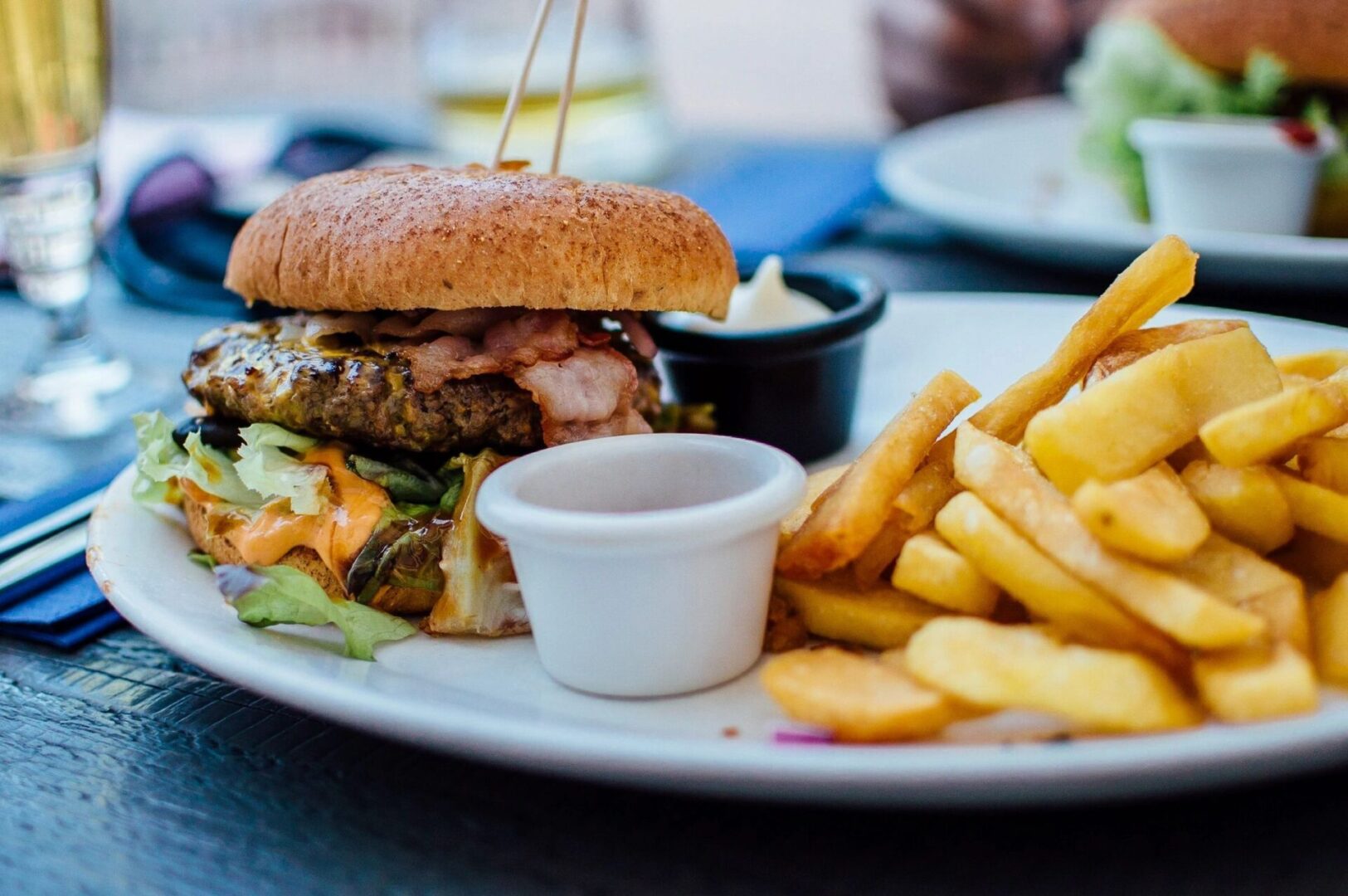 A plate of food with fries and a sandwich.