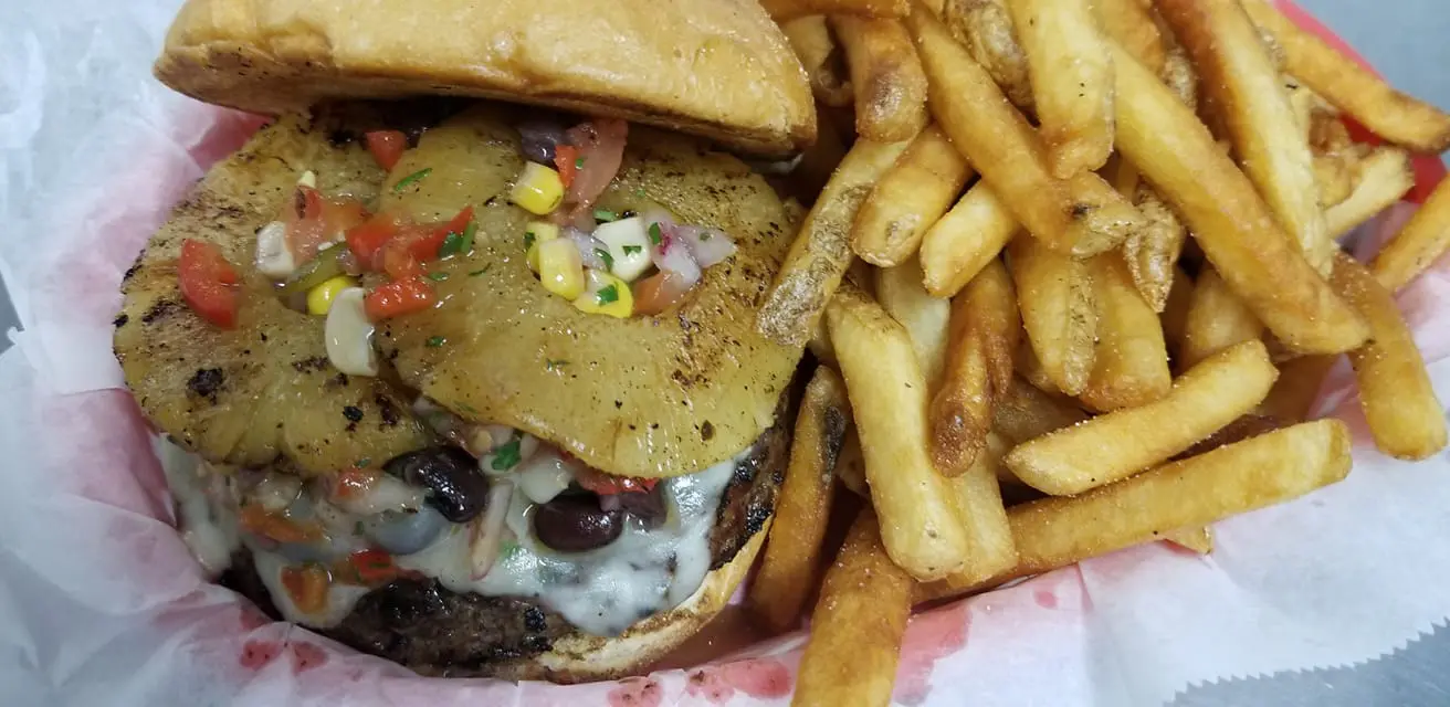 A hamburger and fries are on the table.